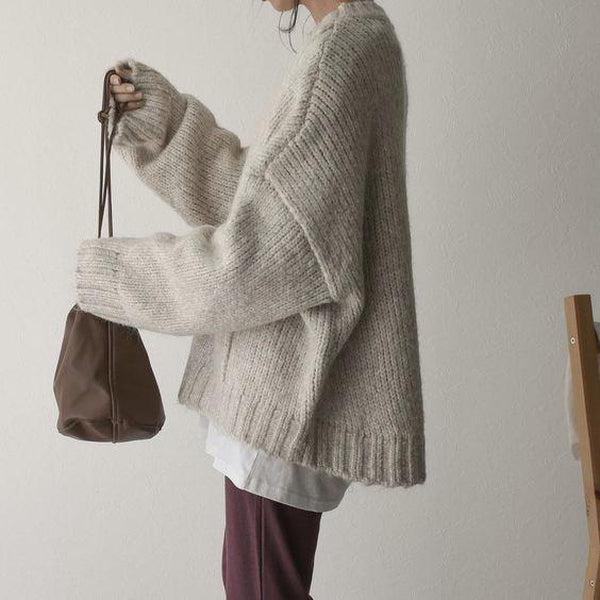 Oversized beige sweater with front pockets